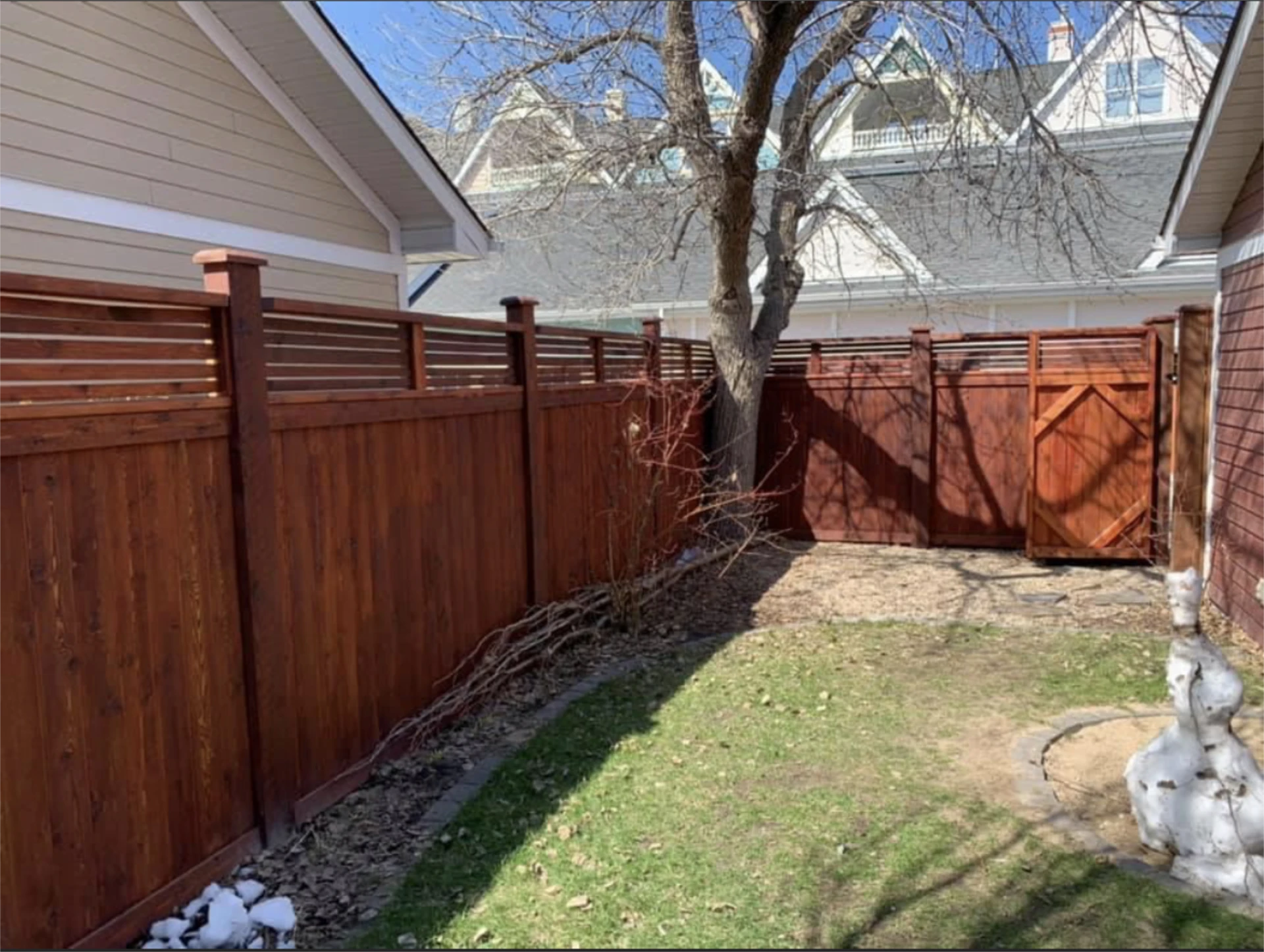 Backyard cedar fence with lattice top and gate.