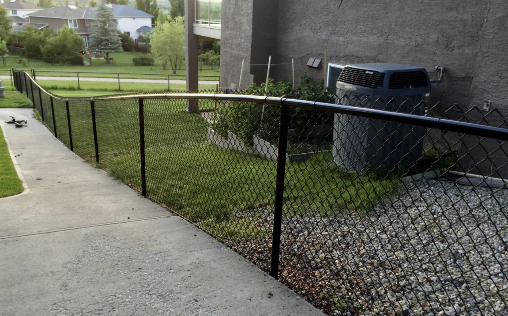 Black chain link fence beside a yard