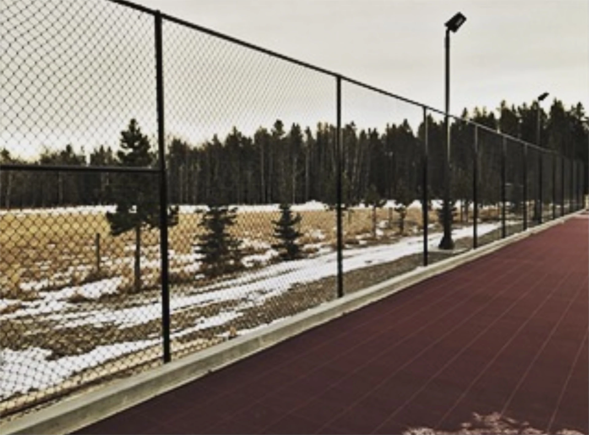 Chain link fence along a running track