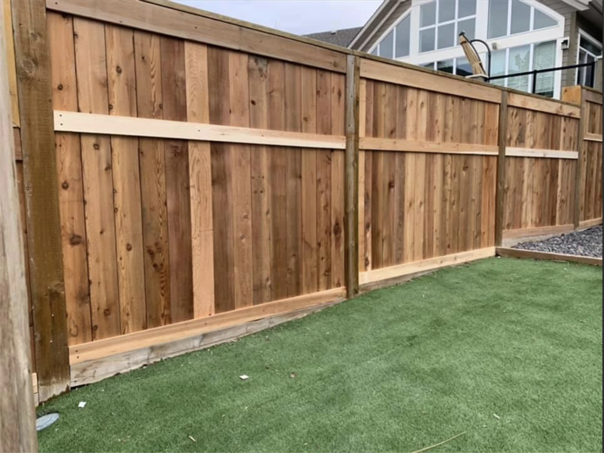 Close up of newly repaired cedar fence panel.