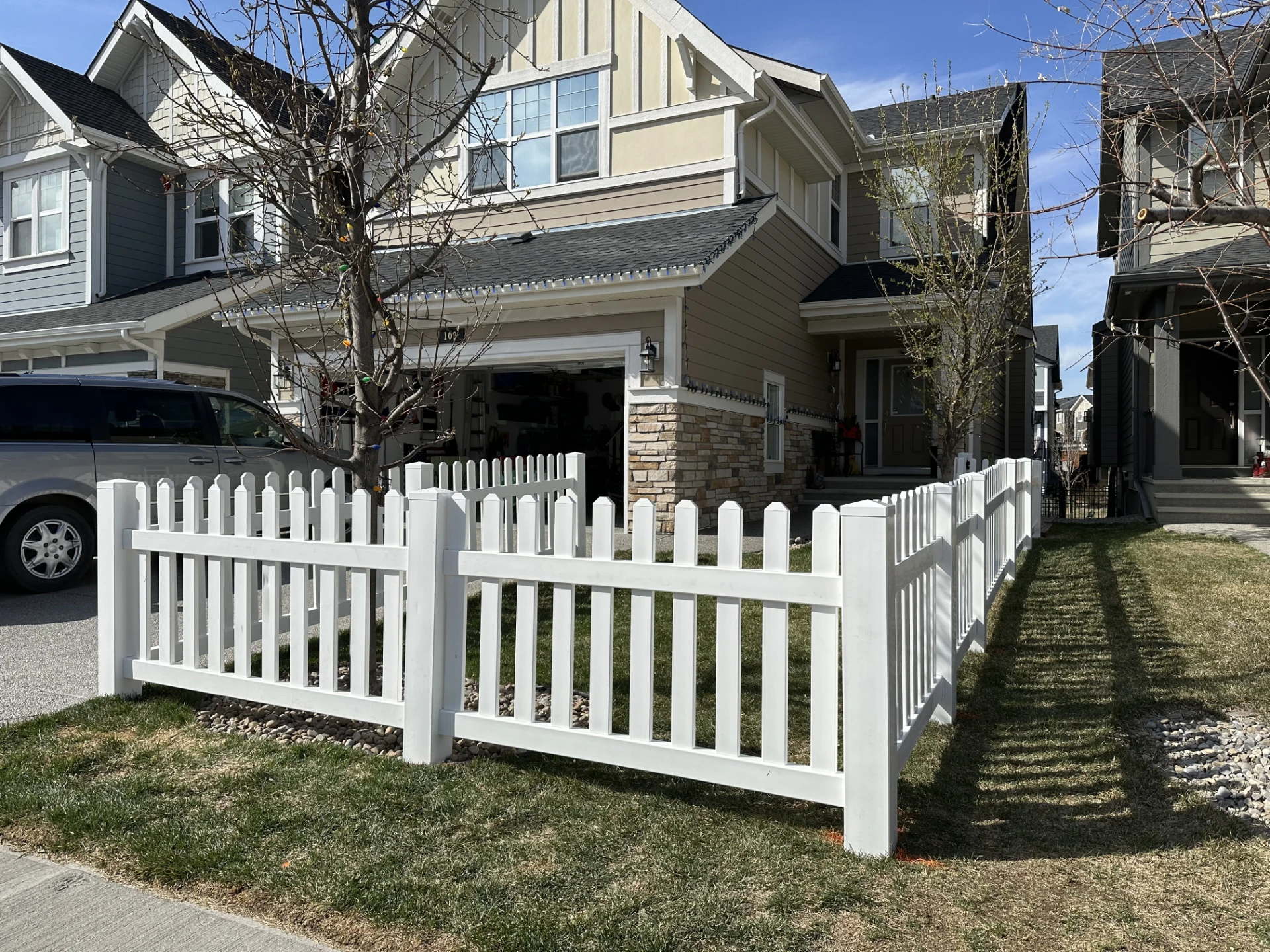 Front view of house with white picket fence