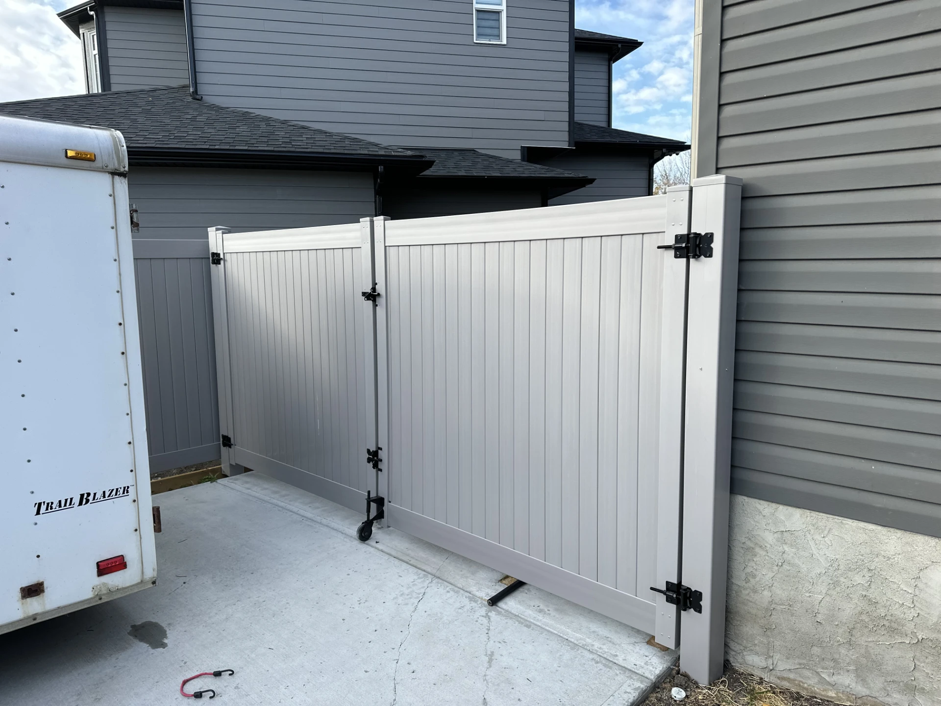 Gray vinyl double driveway gate, side view