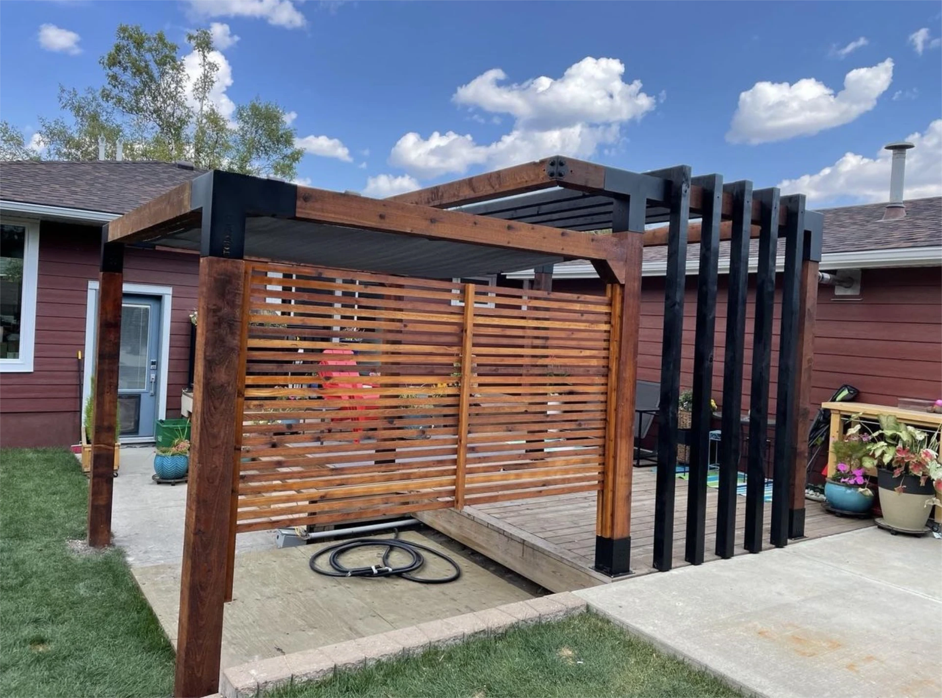 Modern wood pergola with privacy slat wall