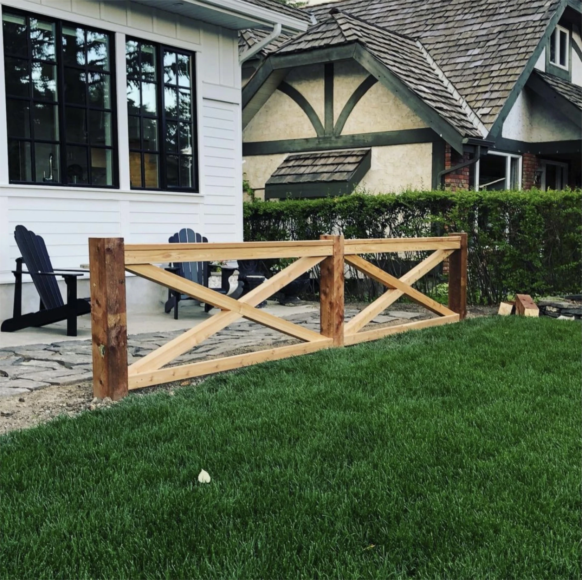 Rustic cedar ranch style fence by patio.