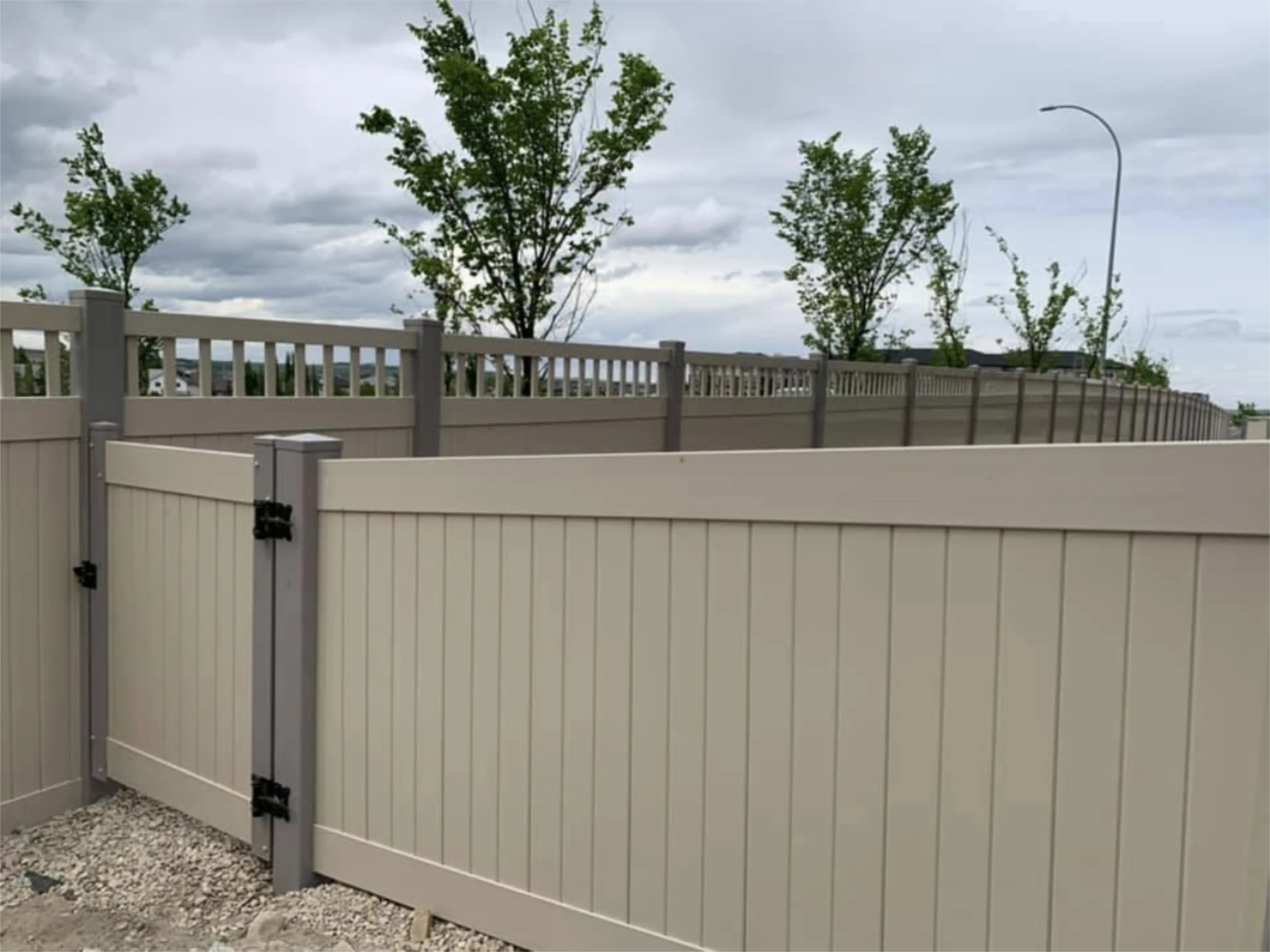 Beige vinyl fence and with the small gate with lattice top design