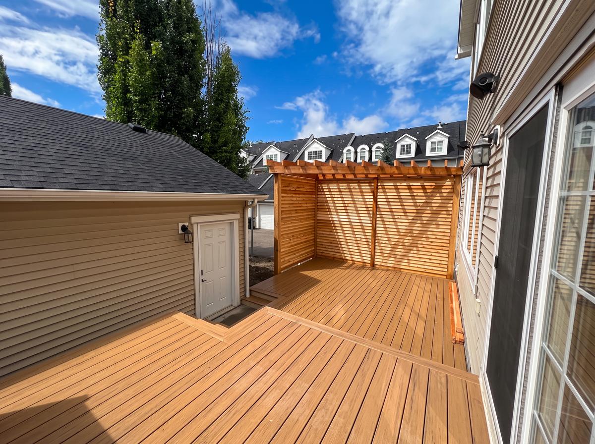 Composite deck with cedar pergola and slat privacy screen in Calgary, AB