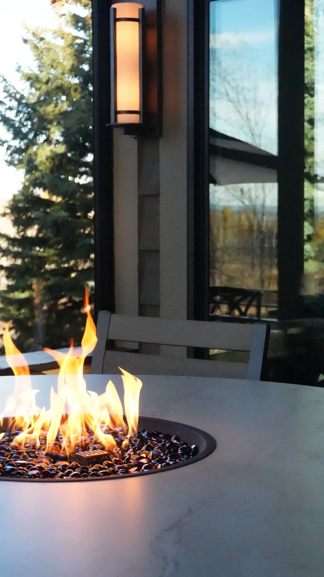 Quartz-top gas fire table on a covered deck in Calgary, AB