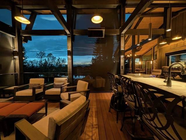 Covered deck lounge and bar lit at dusk