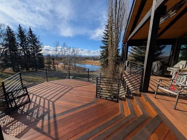 Covered deck with black railing overlooking the water
