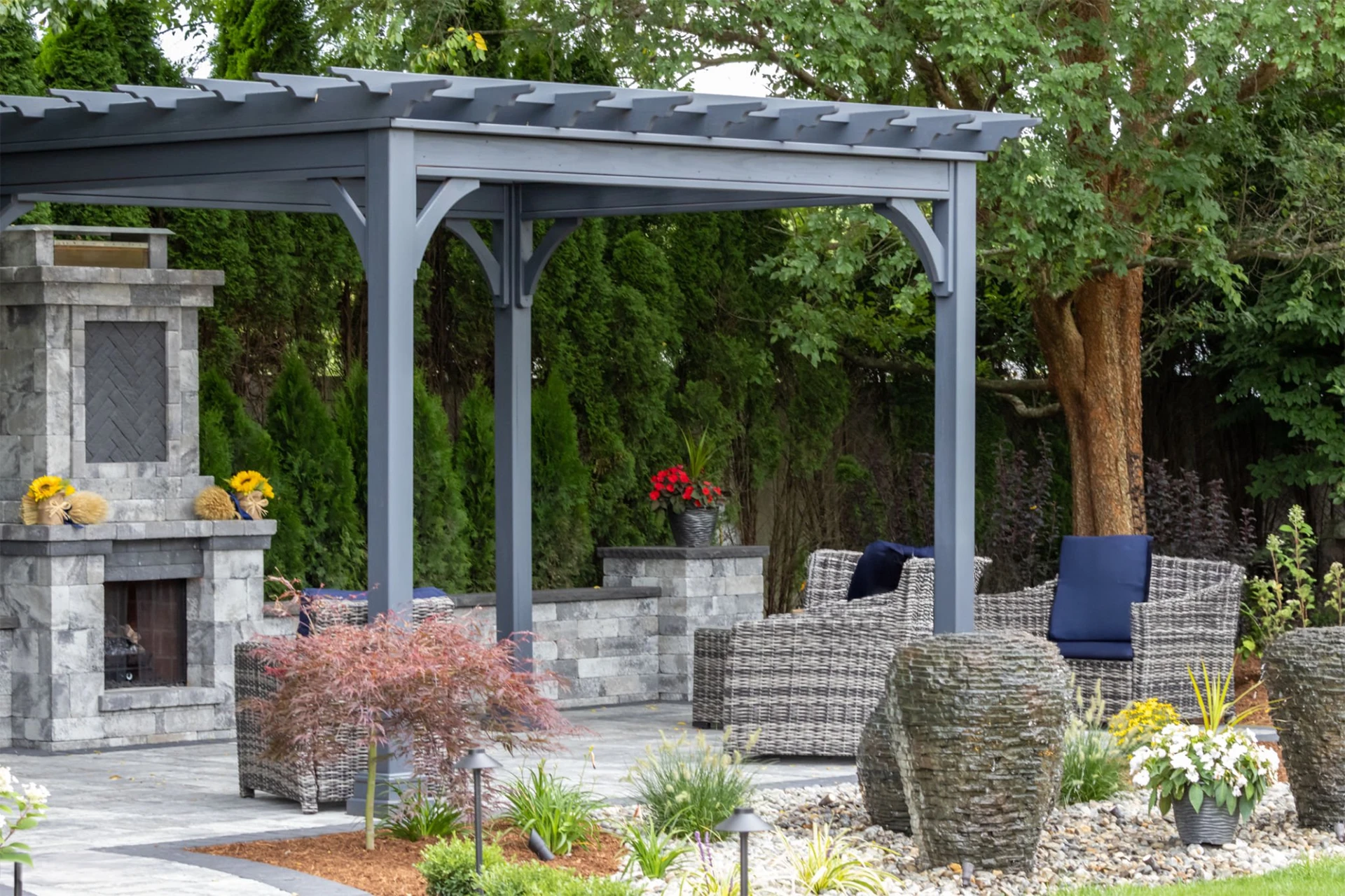 Landscape architecture featuring pergola and stone fireplace
