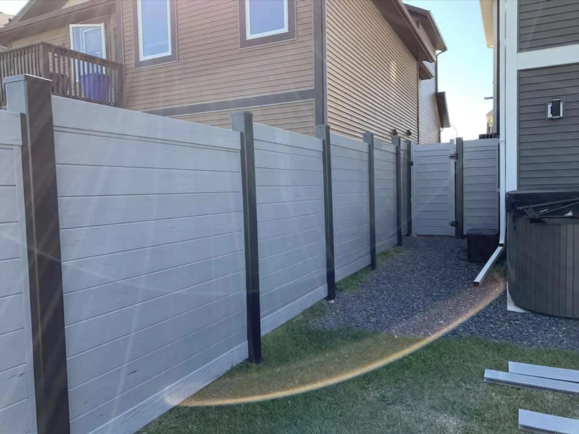 Moden gray composite privacy fence between homes