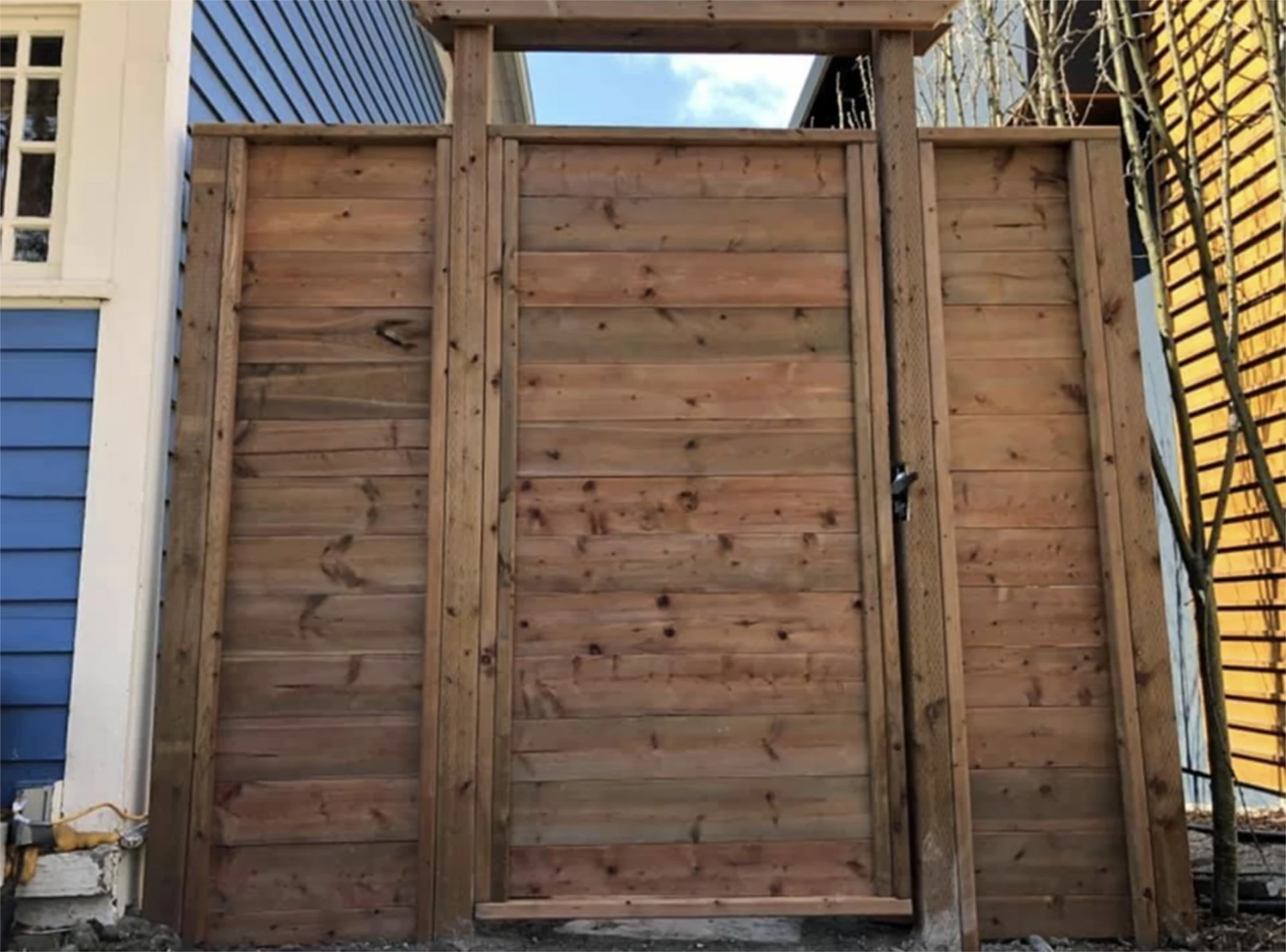 Perspective view of modern horizontal cedar gate and fence panel