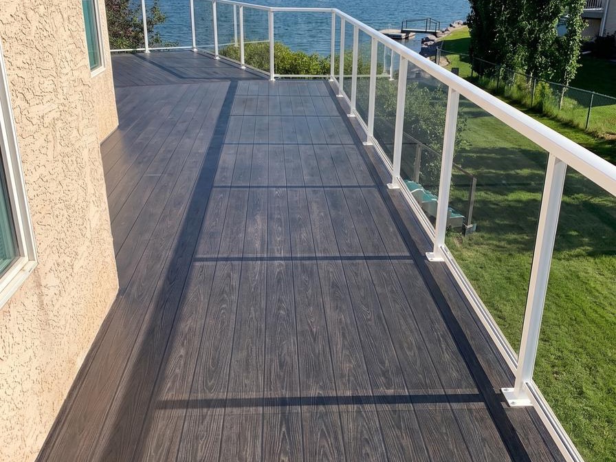 Dark woodgrain vinyl deck planks on a lakefront balcony in Calgary, AB
