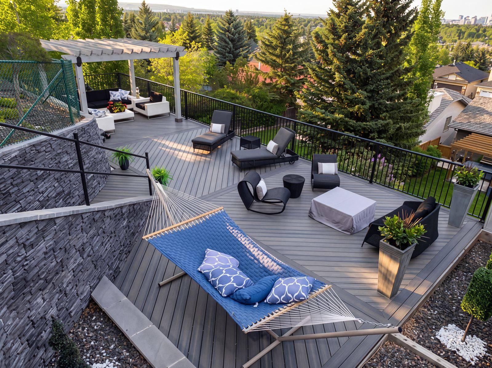 White pergola over lounge seating on a grey composite deck