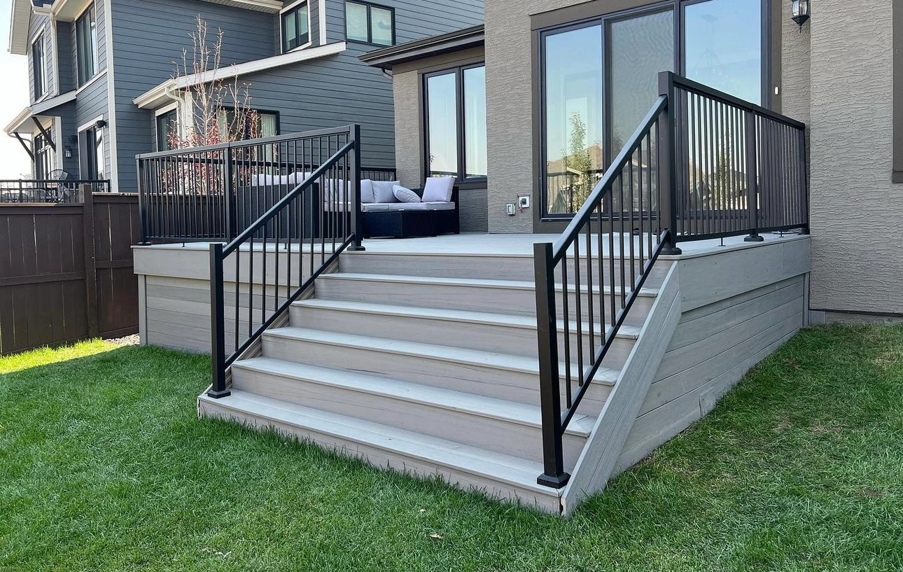 White stairs with black railing on the big house